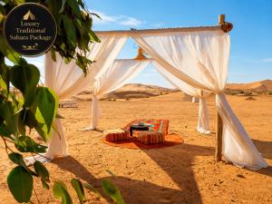 a tent with two beds in the desert at Luxury Traditional Sahara Package in Merzouga