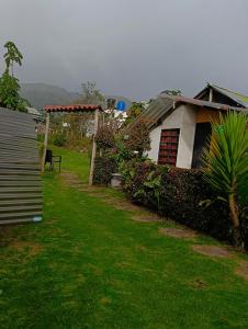 a house in a yard with a grass field at Bahareque hospedaje in Monguí +9 photos