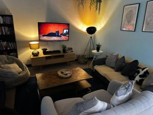 a living room with a couch and a table at Curraheen Point Cork - Easy Access to City Centre in Cork