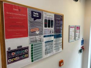 a bulletin board on a wall with signs on it at Curraheen Point Cork - Easy Access to City Centre in Cork