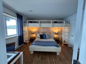 a bedroom with a bed and two bunk beds at Le Quai 163 in La Macaza
