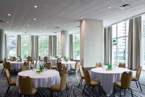 a conference room with tables and chairs and windows at Vancouver Marriott Pinnacle Downtown Hotel in Vancouver