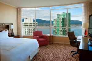 a hotel room with a bed and a large window at Vancouver Marriott Pinnacle Downtown Hotel in Vancouver
