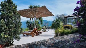 a patio with a chair and an umbrella at Finca Villa Rosita 26 in Copacabana