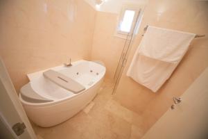a white bathroom with a toilet and a shower at Antica Masseria Ficazzana - Tenuta in Marina di Pescoluse