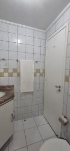 a white bathroom with a toilet and a sink at Praia do Forte - AP DA PAZ in Cabo Frio +39 photos