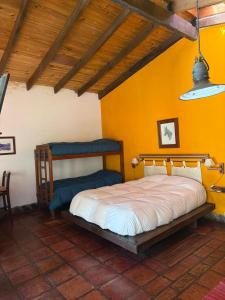 a bedroom with a bed in a room with yellow walls at Ashpa apart in Cafayate