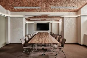 a conference room with a wooden table and chairs at AC Hotel by Marriott Wroclaw in Wrocław +98 photos