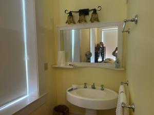 a bathroom with a sink and a mirror at Catherine's Palace in Vicksburg