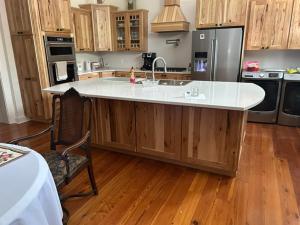 a kitchen with a large island in the middle of it at Catherine's Palace in Vicksburg +5 photos