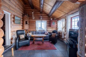 a living room in a log cabin with a table and chairs at Ideal For Families 6 Bedrooms And Sauna in Beitostøl
