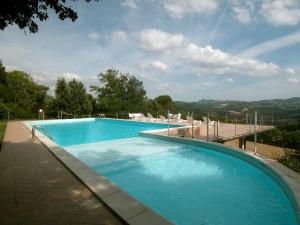 a large swimming pool with blue water in a yard at Mansion in Citerna with Pool & Garden in Citerna
