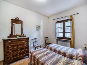 a bedroom with two beds and a dresser and a mirror at Mansion in Citerna with Pool & Garden in Citerna +32 photos
