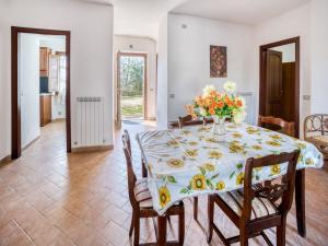 a dining room with a table with a vase of flowers on it at Mansion in Citerna with Pool & Garden in Citerna