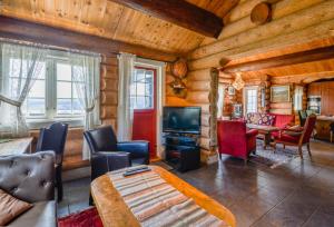 a living room in a log cabin with a television at Ideal For Families 6 Bedrooms And Sauna in Beitostøl +37 photos