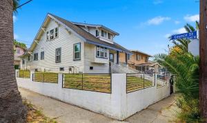 a white house with a fence in front of it at Journey House LA in Los Angeles +3 photos