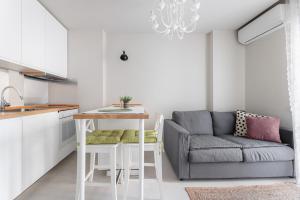 a living room with a couch and a table at Lumahaus Chamber Palaiologou in Thessaloniki