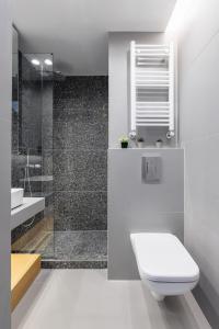 a white bathroom with a toilet and a shower at White Tower Elegance in Thessaloniki +38 photos