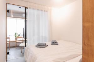 a bedroom with a bed with towels on it at Skg Cityscape Metropolis in Thessaloniki