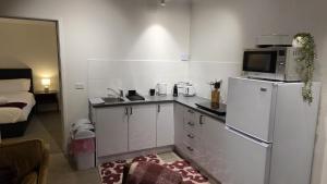 a kitchen with a white refrigerator and a microwave at Alpinwood in Dinner Plain