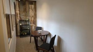 a room with a table and two chairs and a shelf at Alpinwood in Dinner Plain