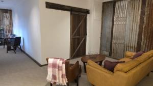 a living room with two couches and a table at Alpinwood in Dinner Plain +1 photo