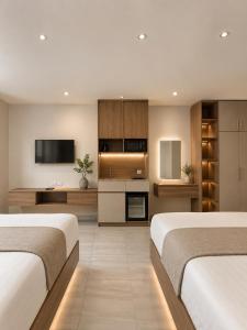 two beds in a room with a kitchen at King's Gate Royal View INN in Cairo