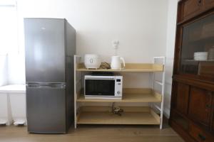 a kitchen with a refrigerator and a microwave at Samurai Hotel - Vacation STAY 22111v in Fujiyoshida