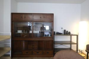a wooden cabinet with glass doors in a living room at Samurai Hotel - Vacation STAY 22111v in Fujiyoshida +55 photos