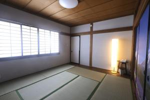 an empty room with two windows and a lamp at Samurai Hotel - Vacation STAY 22111v in Fujiyoshida