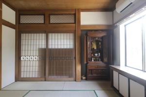 an entrance to a room with a door and a window at Samurai Hotel - Vacation STAY 22111v in Fujiyoshida