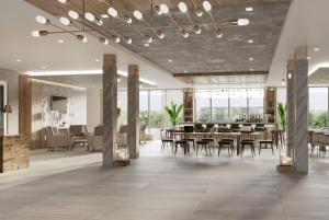 a dining room with tables and chairs in a building at Wyndham Garden Sartell/St. Cloud in Sartell