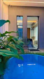 a house with a plant in front of it at Flat em Carapibus moderno e aconchegante in Conde