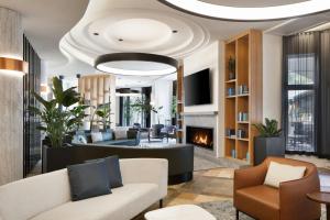 a living room with a couch and a fireplace at Le Westin Tremblant in Mont-Tremblant