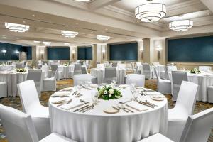 a conference room with white tables and white chairs at Le Westin Tremblant in Mont-Tremblant +46 photos