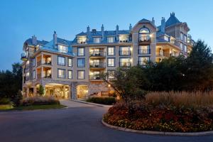 a large building with a driveway in front of it at Le Westin Tremblant in Mont-Tremblant