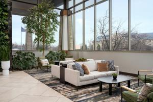 a lobby with a couch and tables and windows at Indianapolis Marriott East in Indianapolis +55 photos