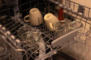 a dish rack with dishes and glasses in it at 104 - Suva City Views Oceanfront Backyard in Suva +24 photos