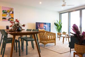 a living room with a wooden table and chairs at 104 - Suva City Views Oceanfront Backyard in Suva