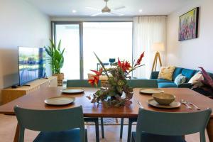 a living room with a wooden table and chairs at 104 - Suva City Views Oceanfront Backyard in Suva