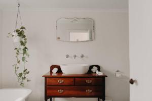 a bathroom with a sink and a mirror at Balnagown in Albany +32 photos