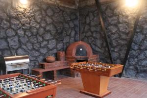 a stone walled room with a table and an oven at Búnker de Coco in Pachacamac