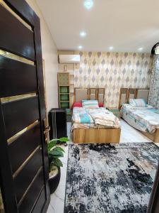 a room with two beds and a door at شقة للإيجار طنطا in Tanta