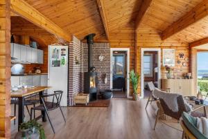 a kitchen and living room with a fireplace in a house at G256-Lemvig-Bellisvej-56 in Lemvig +23 photos