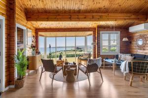 a living room with a table and chairs with a view at G256-Lemvig-Bellisvej-56 in Lemvig