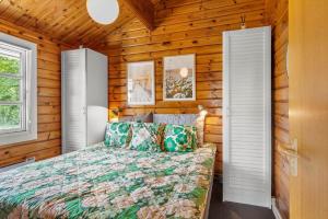 a bedroom with a bed in a log cabin at G256-Lemvig-Bellisvej-56 in Lemvig