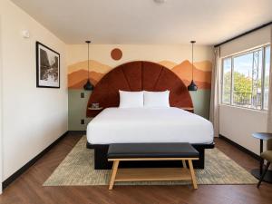 a bedroom with a large white bed and a table at The Wesley Boutique Hotel Page, AZ in Page +22 photos