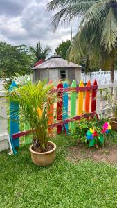 a colorful fence with a plant in front of it at Homestay Sani in Tanah Merah
