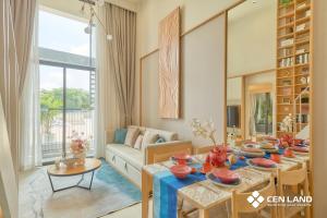 a living room with a table and a couch at Sun Uban City Hà Nam in Quang Ãm