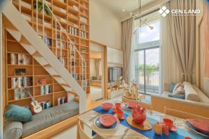 a living room with a staircase and a large book shelf at Sun Uban City Hà Nam in Quang Ãm
